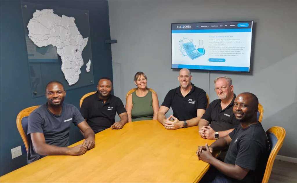 FlexoChem team sitting around a boardroom table during a meeting